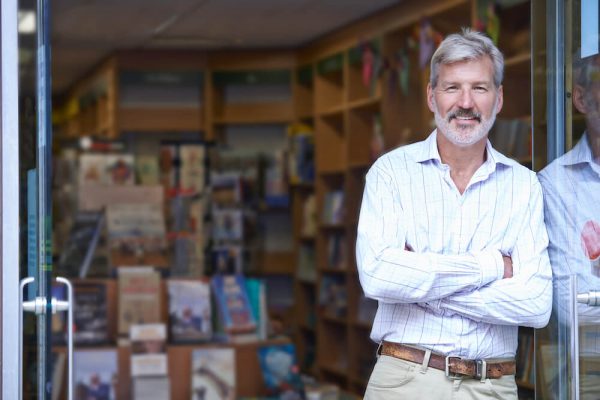 Older man standing outside of bookstore