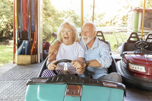 Elderly couple driving bumper car
